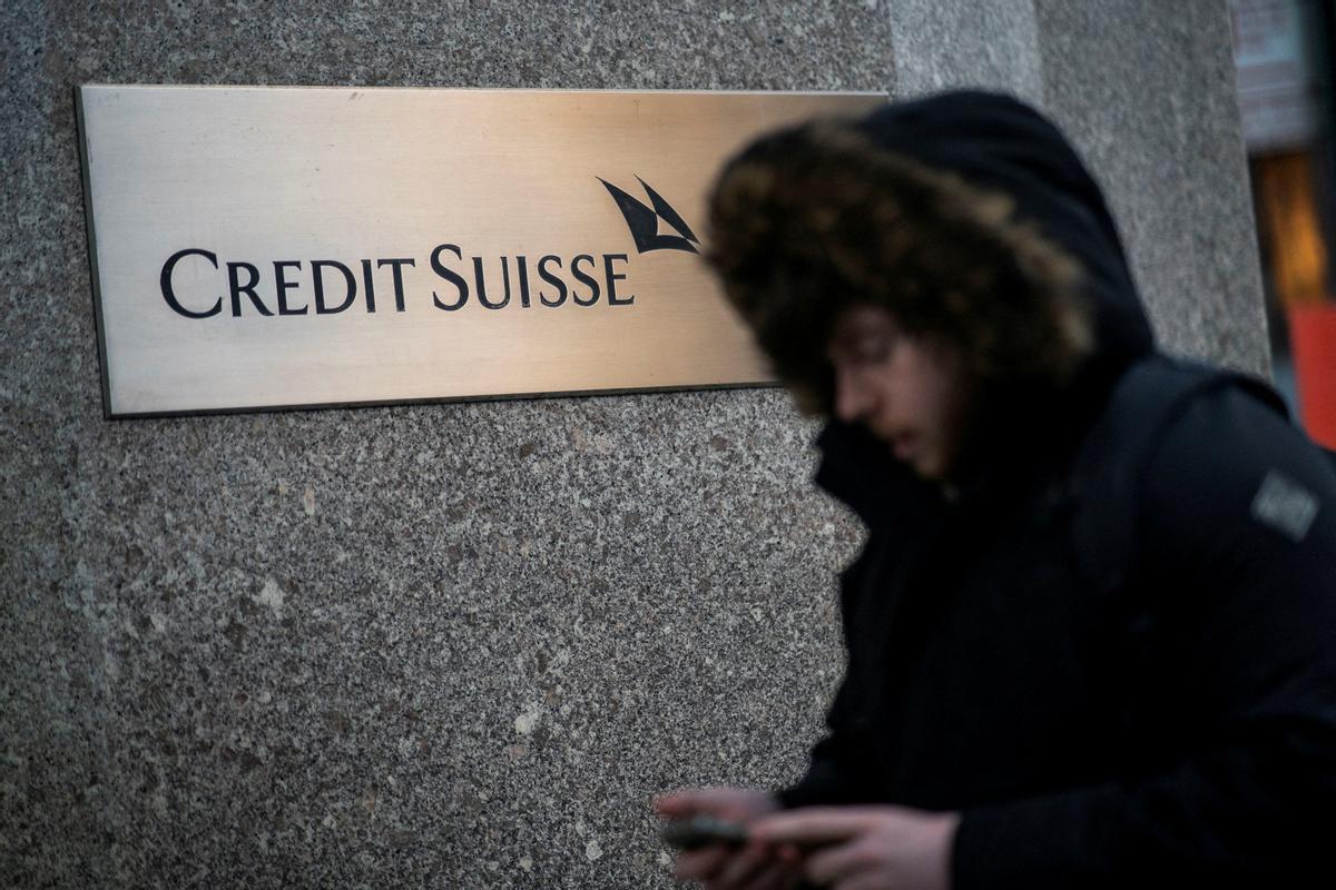 FILE PHOTO: A man walks near the Credit Suisse bank headquarters in New York