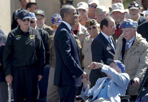 U.S. President Obama laughs as he chats with a war veteran during the 70th French-American Commemoration D-Day Ceremony at the Normandy American Cemetery and Memorial in Colleville-sur-Mer