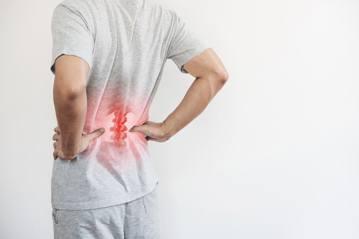 office syndrome backache and lower back pain concept man touching his lower back at pain point