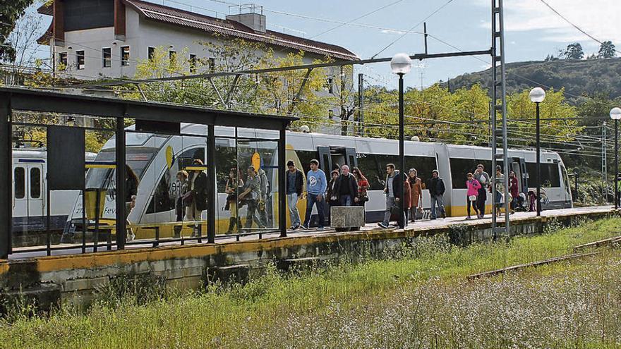 Usuarios de la línea entre Oviedo e Infiesto llegando, ayer, a la estación de Pola de Siero.