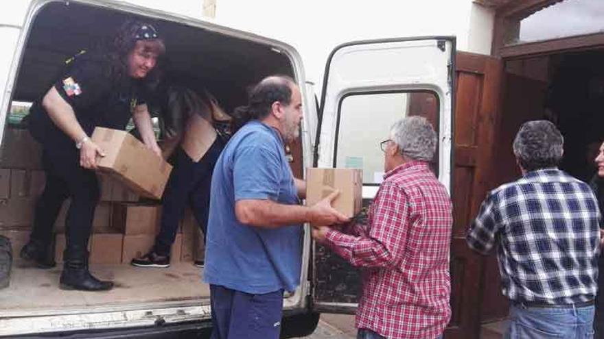 Los voluntarios descargan las ayudas que irán a los campamentos.