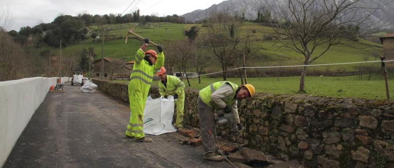 Operarios encargados de la obra para ordenar el río Casaño, ayer, en Poo de Cabrales.