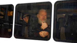 FILE PHOTO  WikiLeaks founder Julian Assange is seen in a police van after was arrested by British police outside the Ecuadorian embassy in London  Britain April 11  2019  REUTERS Henry Nicholls File Photo