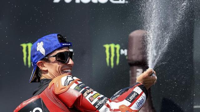 Marc Márquez destapa l’ampolla al podi per celebrar el triomf aconseguit a Brno. | MARTIN DIVISEK / EFE