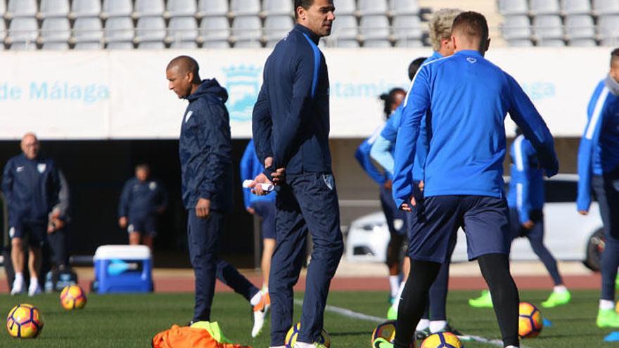 Marcelo Romero, entrenador del Málaga CF, camina pensativo ante la presencia de Weligton, durante un entrenamiento.