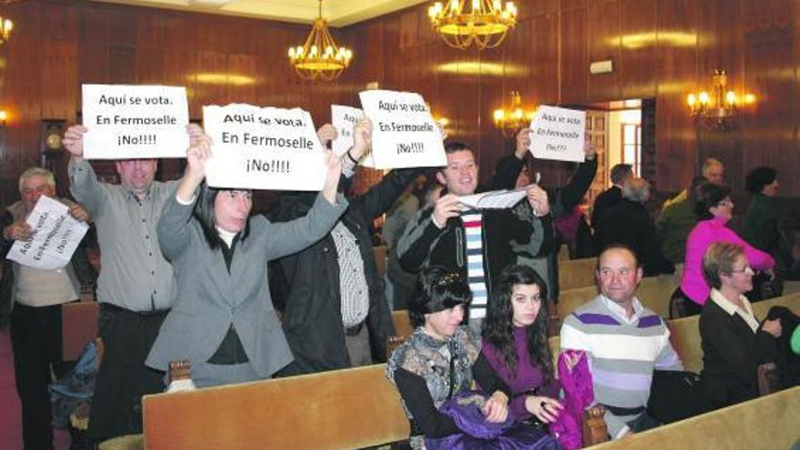 Concejales de la oposición de Fermoselle y personas afines exhiben carteles de protesta durante el Pleno.