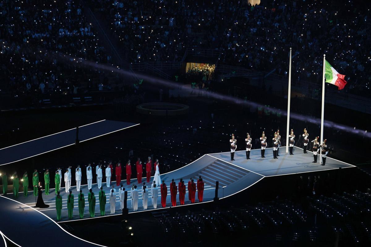 La cantante italiana Laura Pausini interpreta el himno nacional italiano, mientras se iza la bandera italiana durante la Ceremonia.