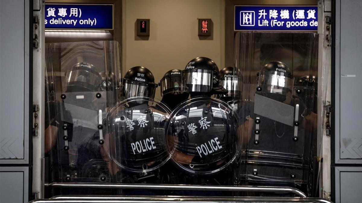 La policía bloquea el acceso al aeropuerto de Hong Kong, este domingo.