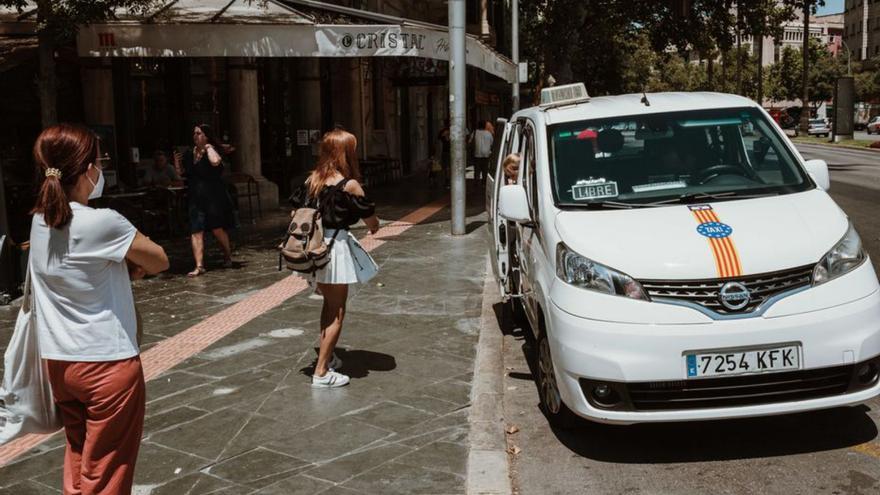 Ciudadanos en una parada de taxis en Palma. | B. ARZAYUS