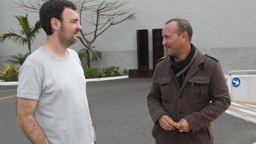 Adolfo García (i), editor y amigo personal del escritor, y Ruso Rodríguez (d), otro de los amigos del poeta, conversan a las puertas del tanatorio de San Miguel donde los restos del artista fallecido ayer reposan hasta su incineración esta tarde.