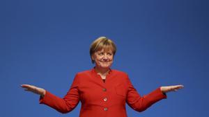 German Chancellor and leader of the conservative CDU Merkel reacts after her speech at the CDU party convention in Essen