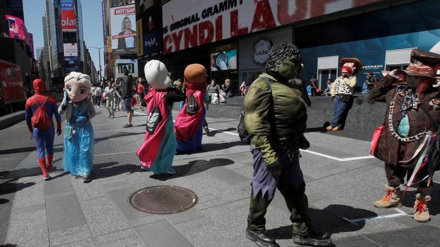 Spiderman, Hulk y el Sombrerero Loco, junto a otros personajes, en Times Square.