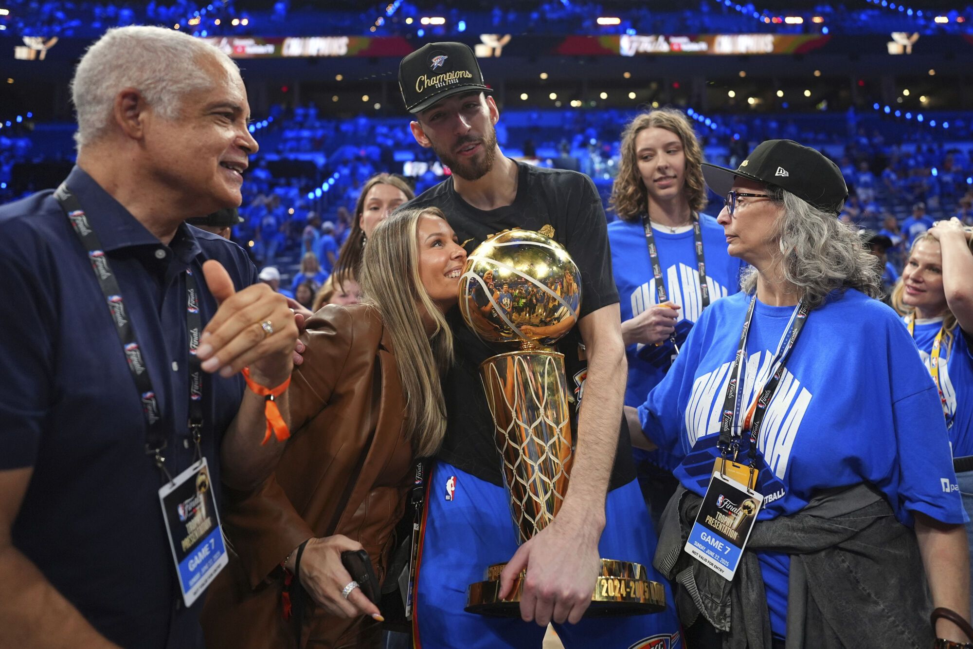 Oklahoma City Thunder forward Chet Holmgren, center, holds the Larry O'Brien Championship Trophy as he celebrates with his team after winning the NBA basketball championship with a Game 7 victory against the Indiana Pacers Sunday, June 22, 2025, in Oklahoma City. (AP Photo/Julio Cortez)