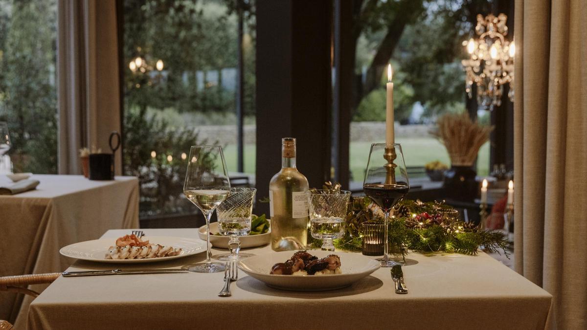 Una taula parada amb decoració nadalenca al restaurant de l'hotel Mas de Torrent.