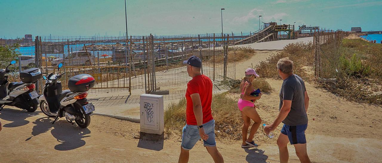 Acceso abierto del paseo sin terminar del dique de Poniente que utilizan los bañistas y paseantes sin respetar el vallado.