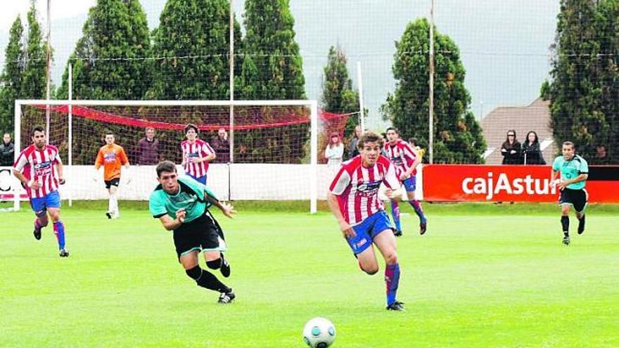 El rojiblanco Juan Muñiz, a la derecha, corre por un balón ante la presión de un jugador del Vecindario.