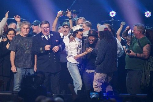 McCartney sings with first responders on stage during the "12-12-12" benefit concert for victims of Superstorm Sandy at Madison Square Garden in New York