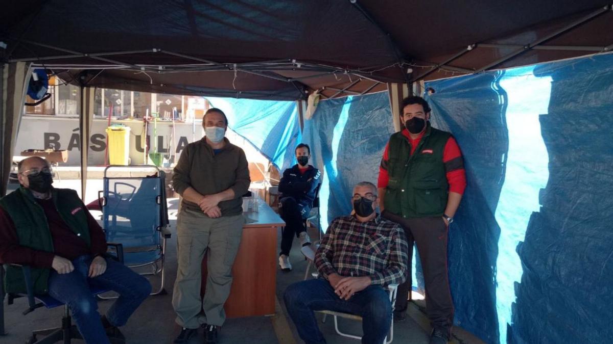 Grupo de trabajadores en la carpa ante la fábrica, que se van rotando por el covid.