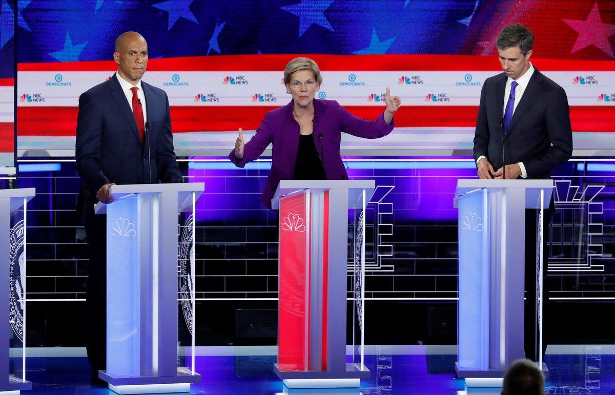 FILE PHOTO  U S  Senator Elizabeth Warren speaks as U S  Senator Cory Booker and former U S  Rep  Beto O Rourke listen at the first U S  2020 presidential election Democratic candidates debate in Miami  Florida  U S   June 26  2019  REUTERS Mike Segar File Photo