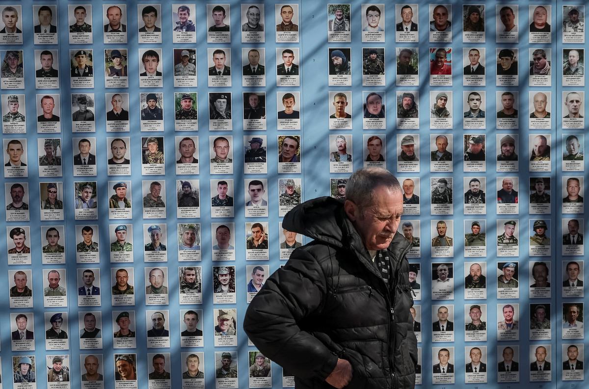 La gente visita el Muro del Recuerdo para conmemorar el Día de los Voluntarios en honor a los combatientes muertos que se unieron a las fuerzas armadas ucranianas.