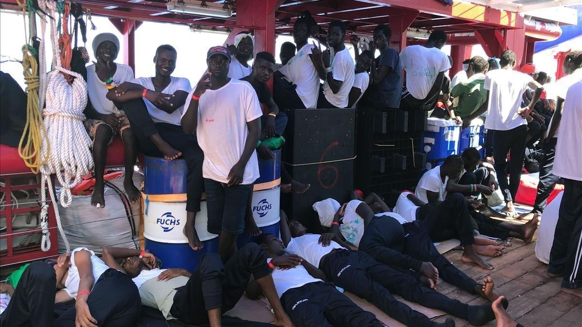 zentauroepp49448619 rescued migrants rest and gesture on the deck of  ocean viki190816194134
