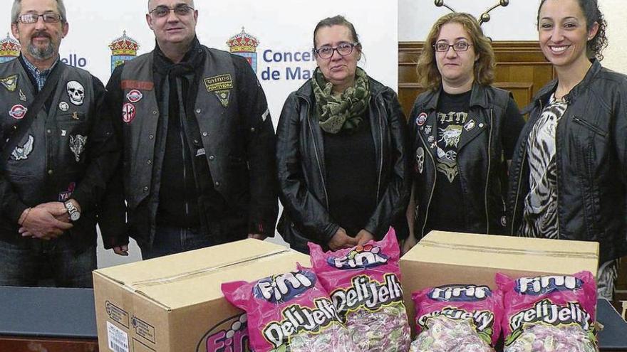 Representantes del Motoclub Taranis recogen en el Concello los caramelos para una caravana navideña.