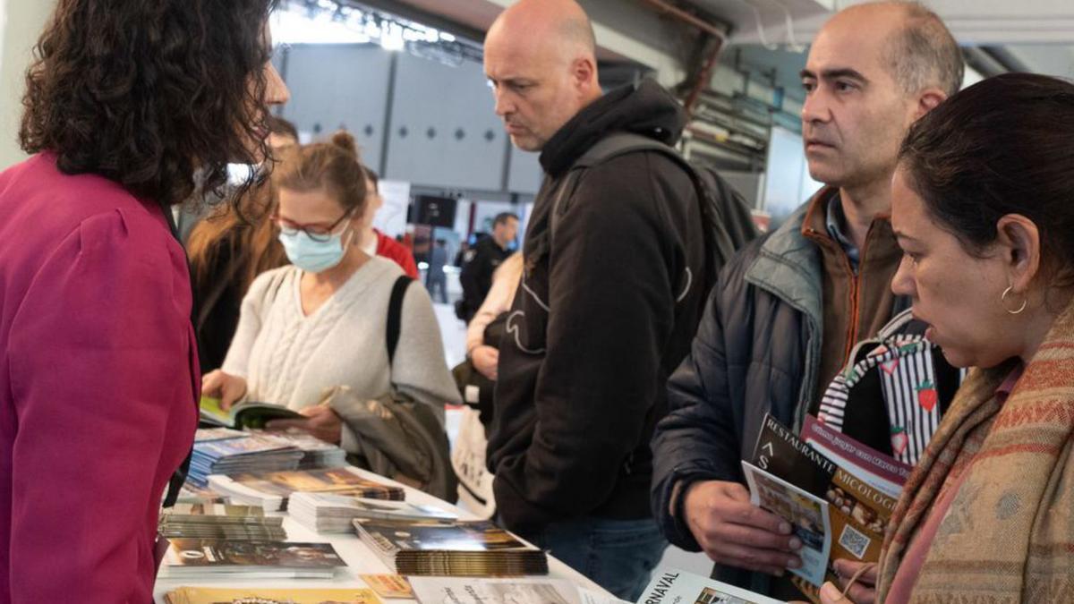 Varias personas consultan información turística. | Jose Luis Fernández