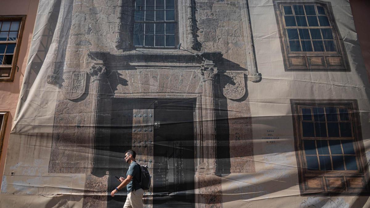 Una persona camina por delante de la clausurada portada de la Casa del Corregidor.