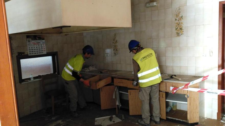 Dos obreros iniciando el desescombro de la cocina