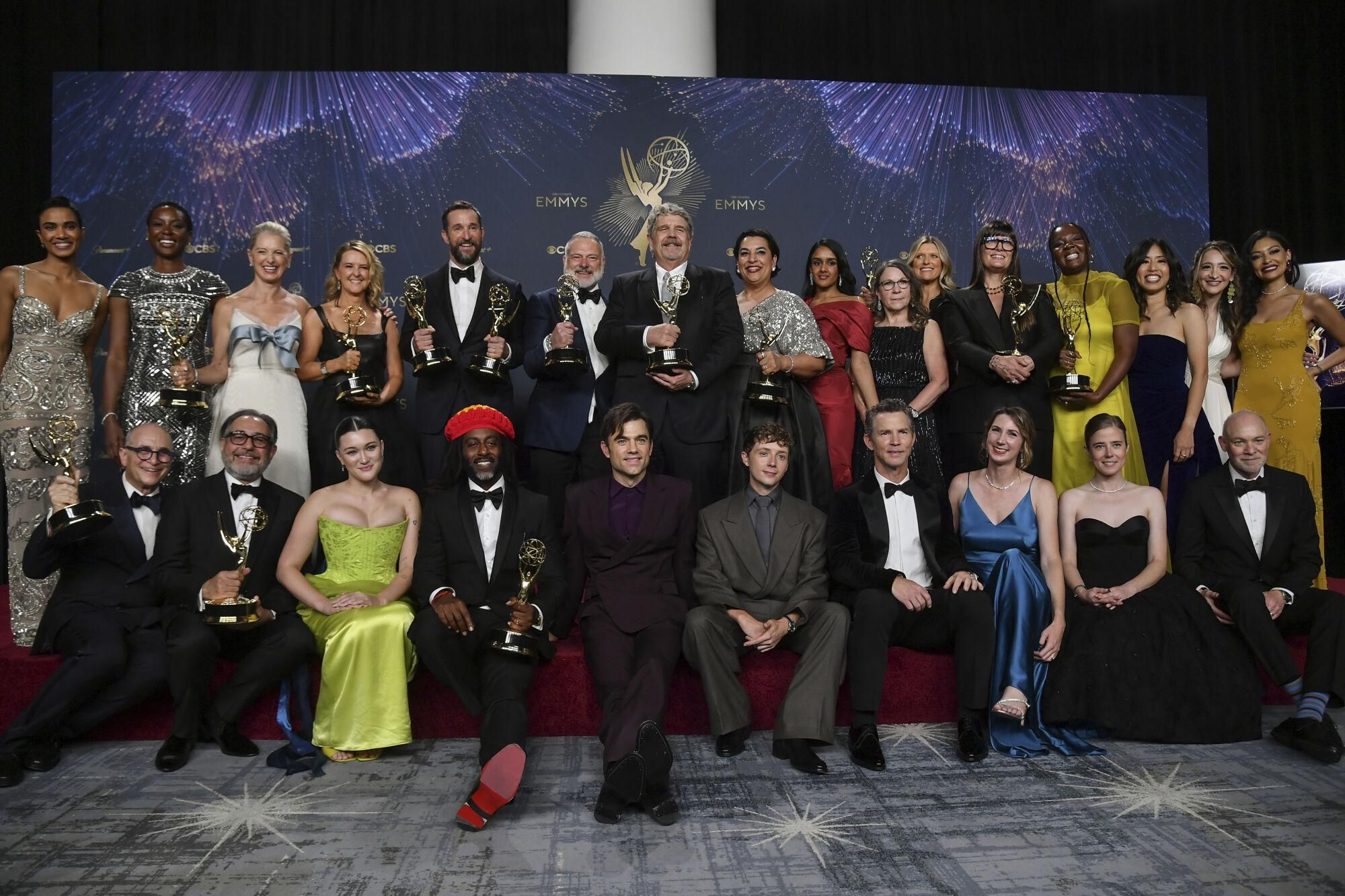 The team from "The Pitt" pose in the press room with the award for outstanding drama series during the 77th Primetime Emmy Awards on Sunday, Sept. 14, 2025, at the Peacock Theater in Los Angeles. (Photo by Richard Shotwell/Invision/AP). 091425132020, 21334631,
