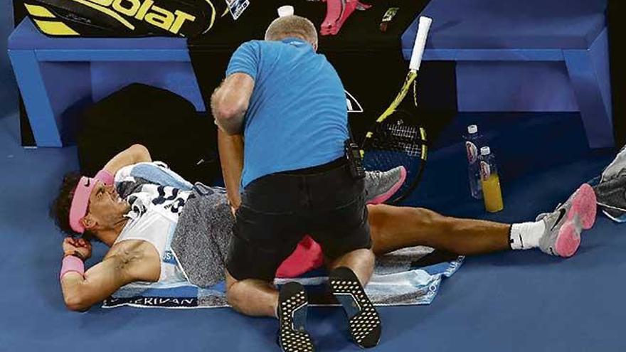Rafel Nadal es atendido por el fisioterapeuta del Abierto de Australia poco antes de abandonar el pasado martes.