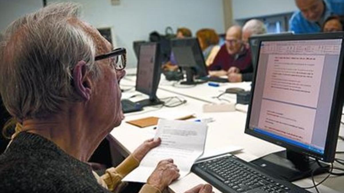 Jubilados aprenden informática en el Espai de Gent Gran Fort Pienc.