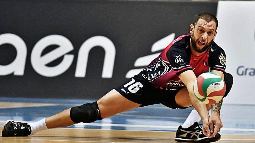 El líbero Carinelli devuelve la pelota a ras de suelo.