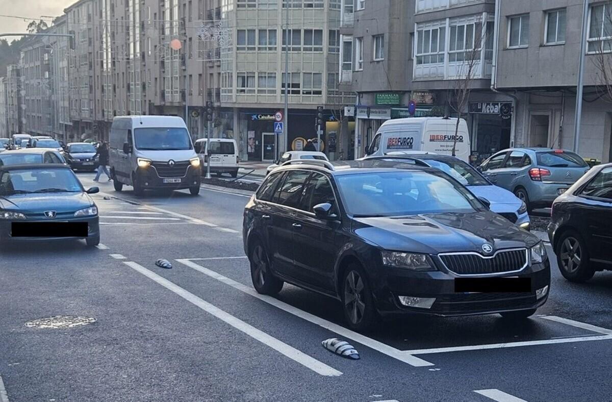 Tráfico denso y vehículos mal aparcados en la travesía principal de Milladoiro