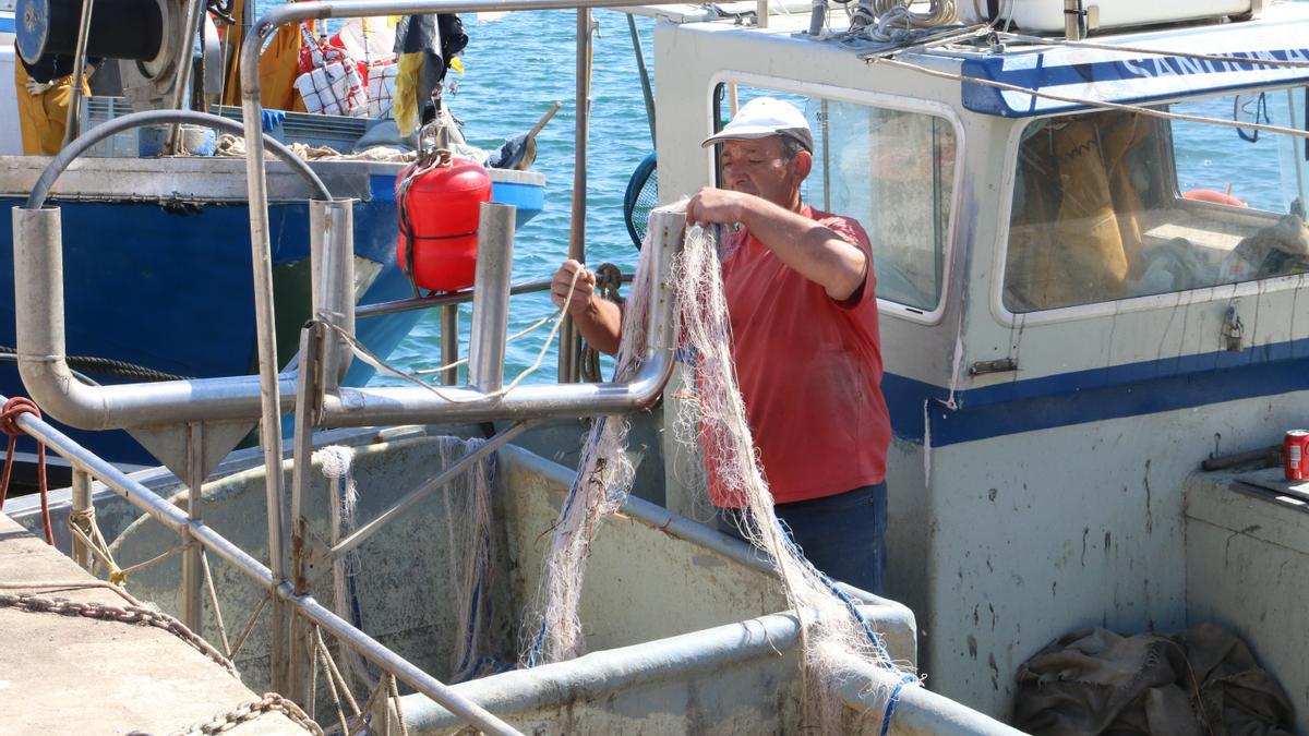 Un pescador feinejant al port pesquer de Roses, en una imatge d'arxiu.