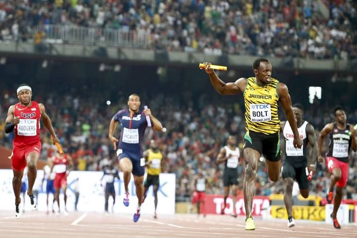 Bolt of Jamaica crosses to finish line to win the men's 4x100m relay during the 15th IAAF World Championships at the National Stadium in Beijing