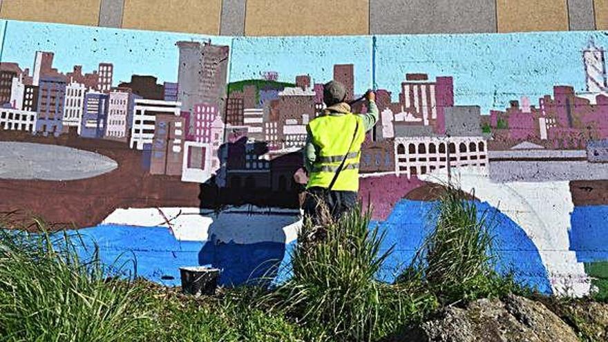 Uno de los impulsores del proyecto del río Monelos pinta parte del muro en la calle Montes.