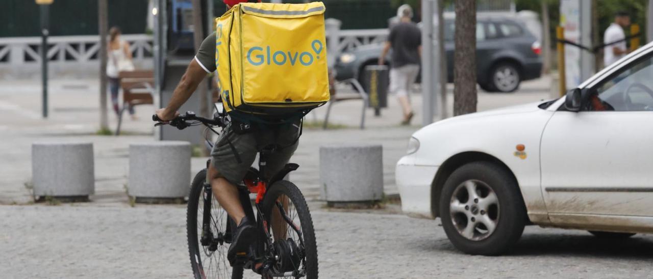 Un repartidor de Glovo a la ciutat de Girona. | ANIOL RESCLOSA