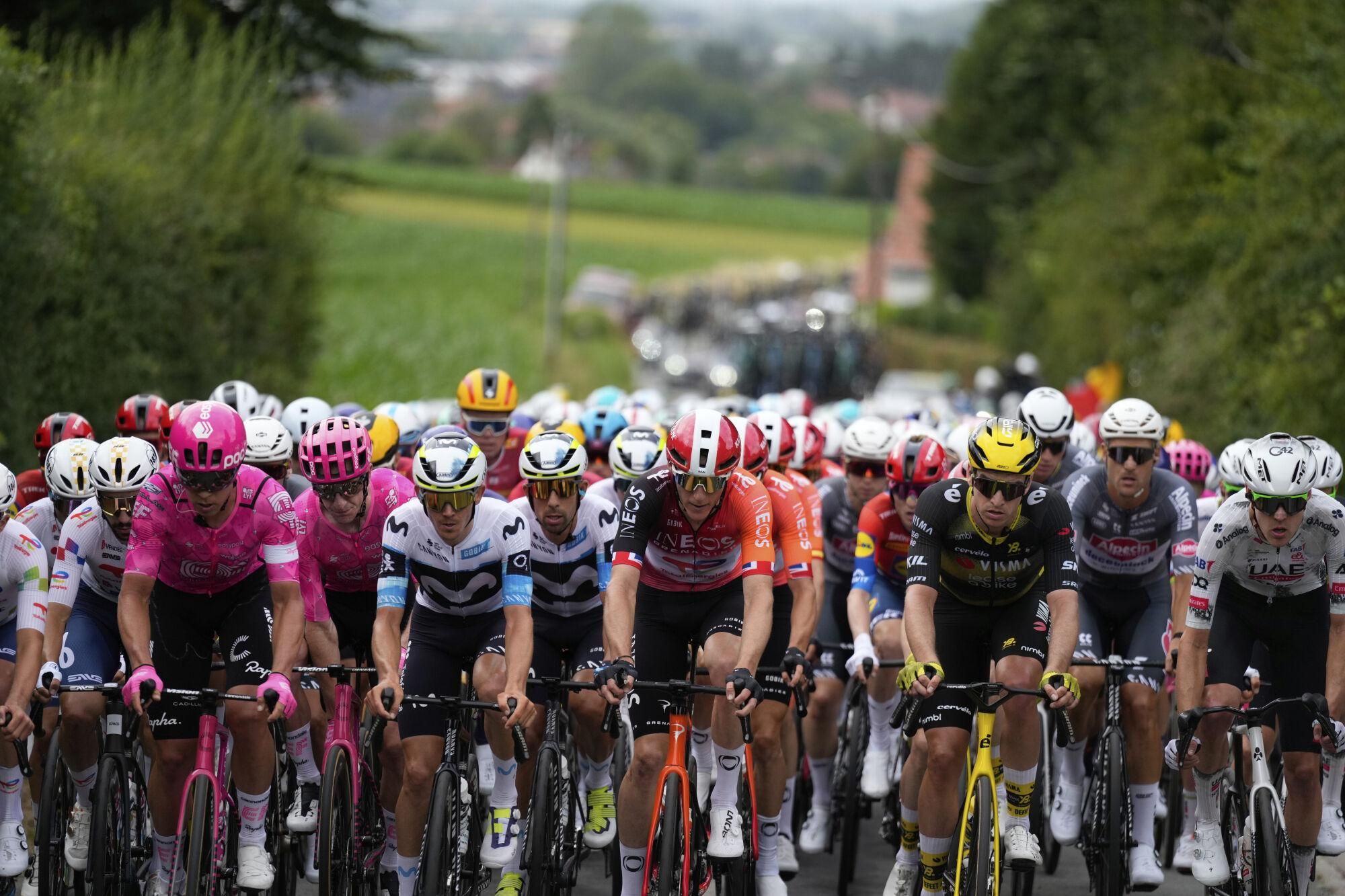 The pack rides during the first stage of the Tour de France cycling race over 184.9 kilometers (114.9 miles) with start and finish in Lille, France, Saturday, July 5, 2025. (AP Photo/Mosa'ab Elshamy). EDITORIAL USE ONLY/ONLY ITALY AND SPAIN