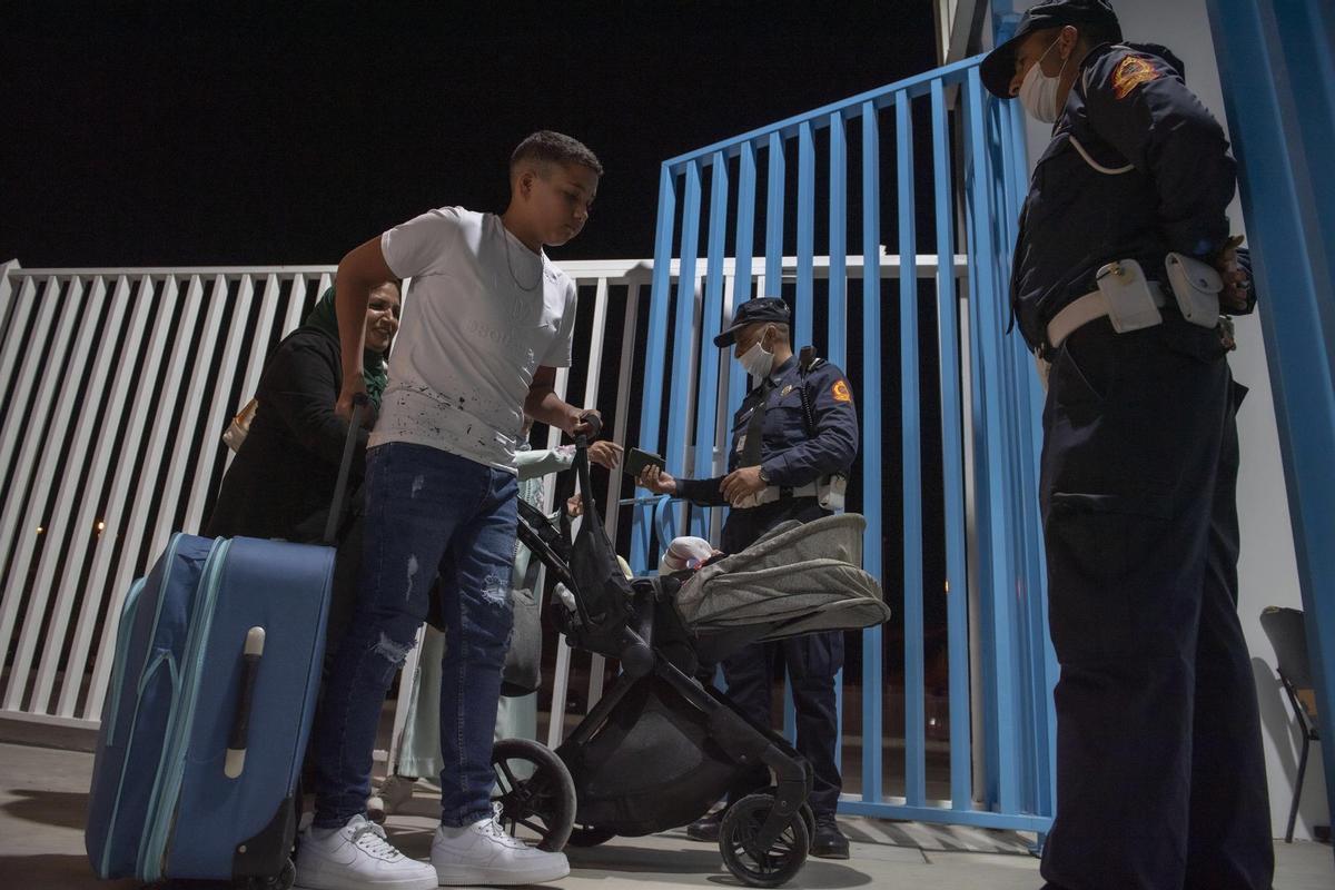 Ceuta (Spain), 17/05/2022.- People are stopped and checked by authorities at a border crossing while leaving the Moroccan city of Fnidef, as seen from Ceuta, Spanish enclave in northern Africa, 17 May 2022. The border between Ceuta and Melilla and northern Africa were opened at midnight on Tuesday after a 26-month closure. (Marruecos, España) EFE/EPA/Jalal Morchidi