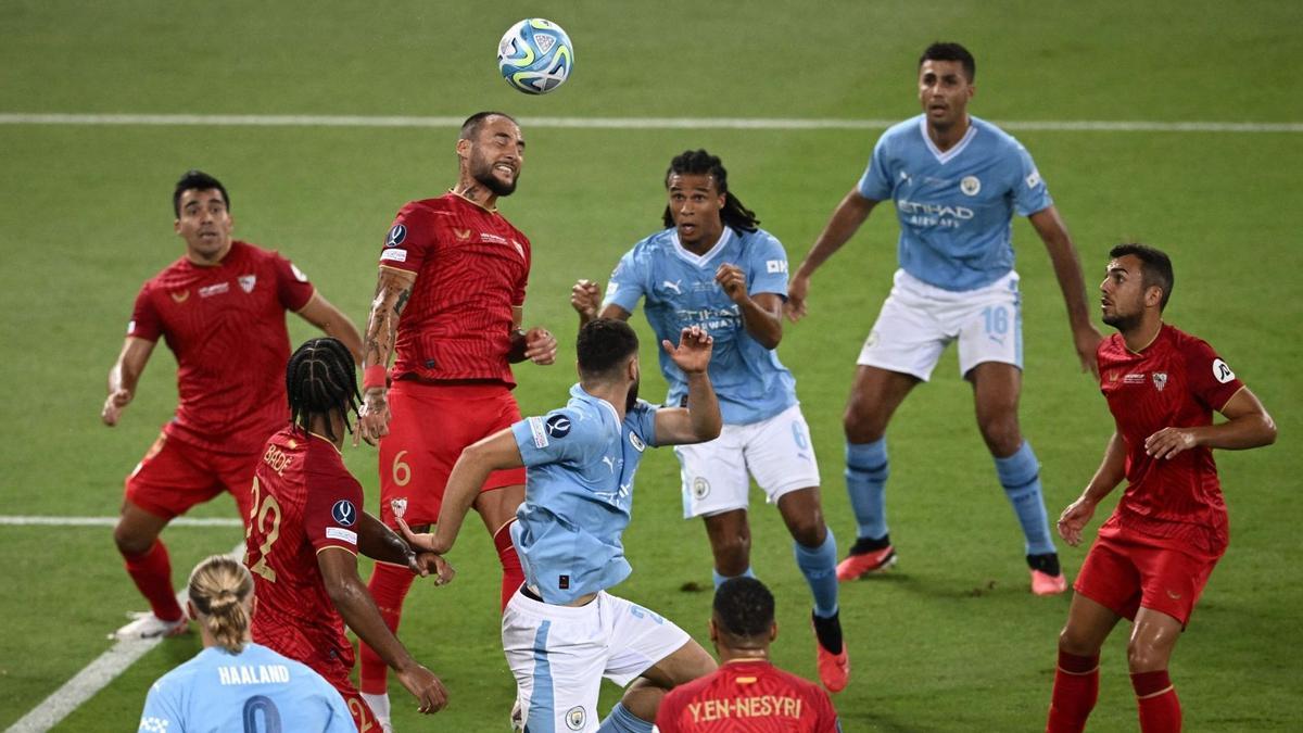 Sevilla's Serbian midfielder #06 Nemanja Gudelj heads the ball during the 2023 UEFA Super Cup football match between Manchester City and Sevilla at the Georgios Karaiskakis Stadium in Piraeus on August 16, 2023. (Photo by Angelos Tzortzinis / AFP)