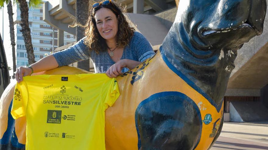 Delante del escenario de sus éxitos, el Centro Insular de Deportes, Patricia posa con la camiseta de la carrera junto a &#039;Granky&#039;.