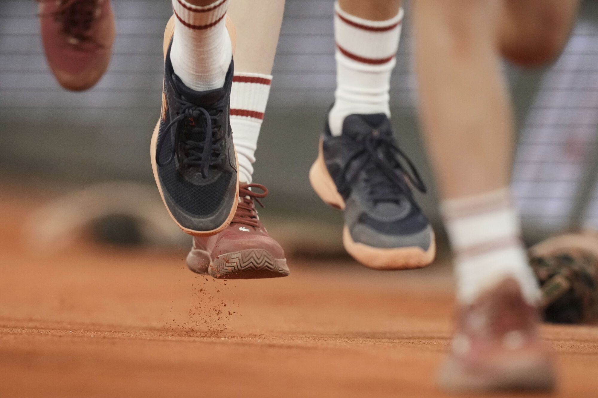 Ball boys run on the court during the second round match of the French Tennis Open between Spain's Carlos Alcaraz and Hungary's Fabian Maroszan, at the Roland-Garros stadium, in Paris, Wednesday, May 28, 2025. (AP Photo/Christophe Ena)