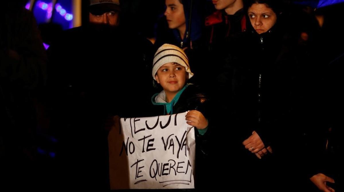 aguasch34489686 a boy holds a sign that reads  messi  don t go  we love you 160628104404