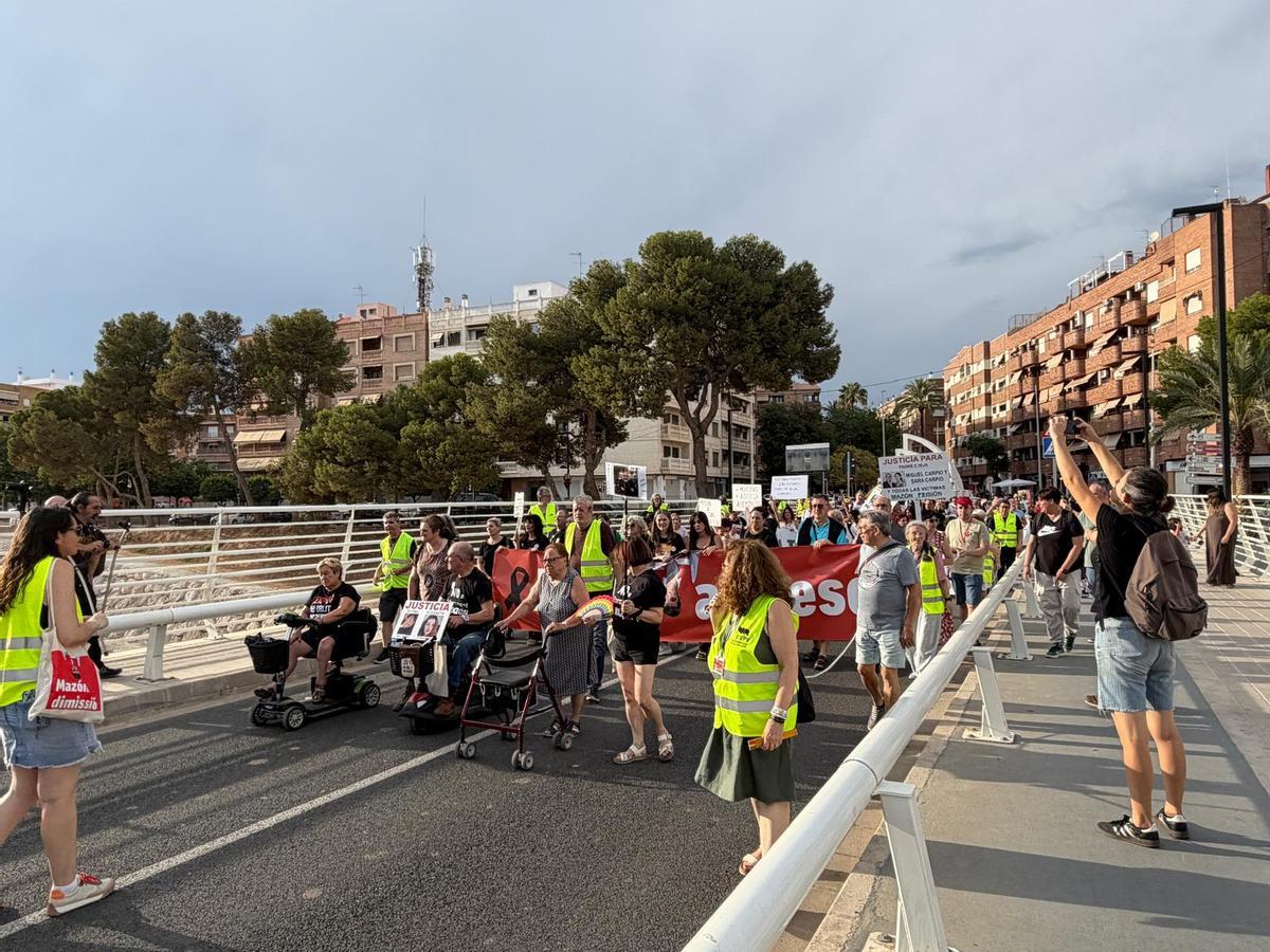 La manifestación cruza el puente del barranco del Poyo.