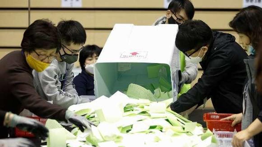 Recuento de votos en una mesa electoral surcoreana, ayer. // Efe