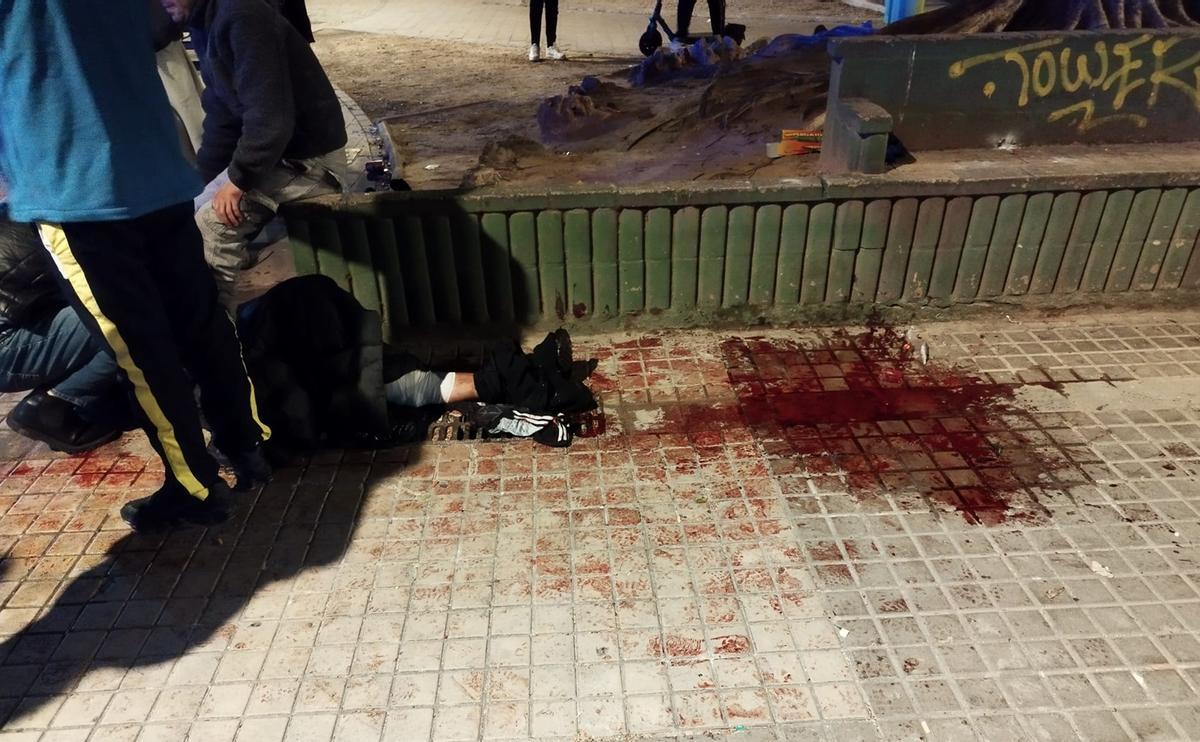 El herido en la plaza de Orriols, que sufrió una fuerte hemorragia, momentos antes de ser atendido.