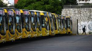 A person walks near parked buses, as bus drivers go on strike, in Vicente Lopez, Buenos Aires, Argentina, April 11, 2024. REUTERS/Mariana Nedelcu