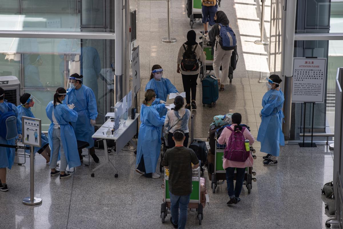 Travellers at Hong Kong Airport Travellers at Hong Kong Airport