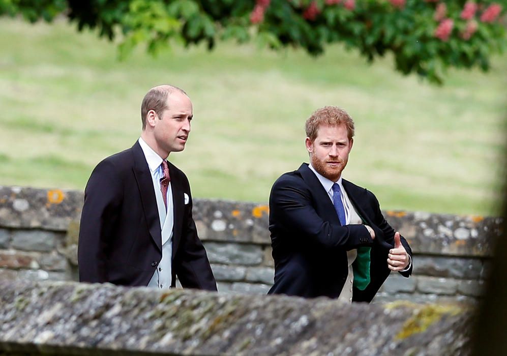 Britain's Prince Harry and Prince William attend ...